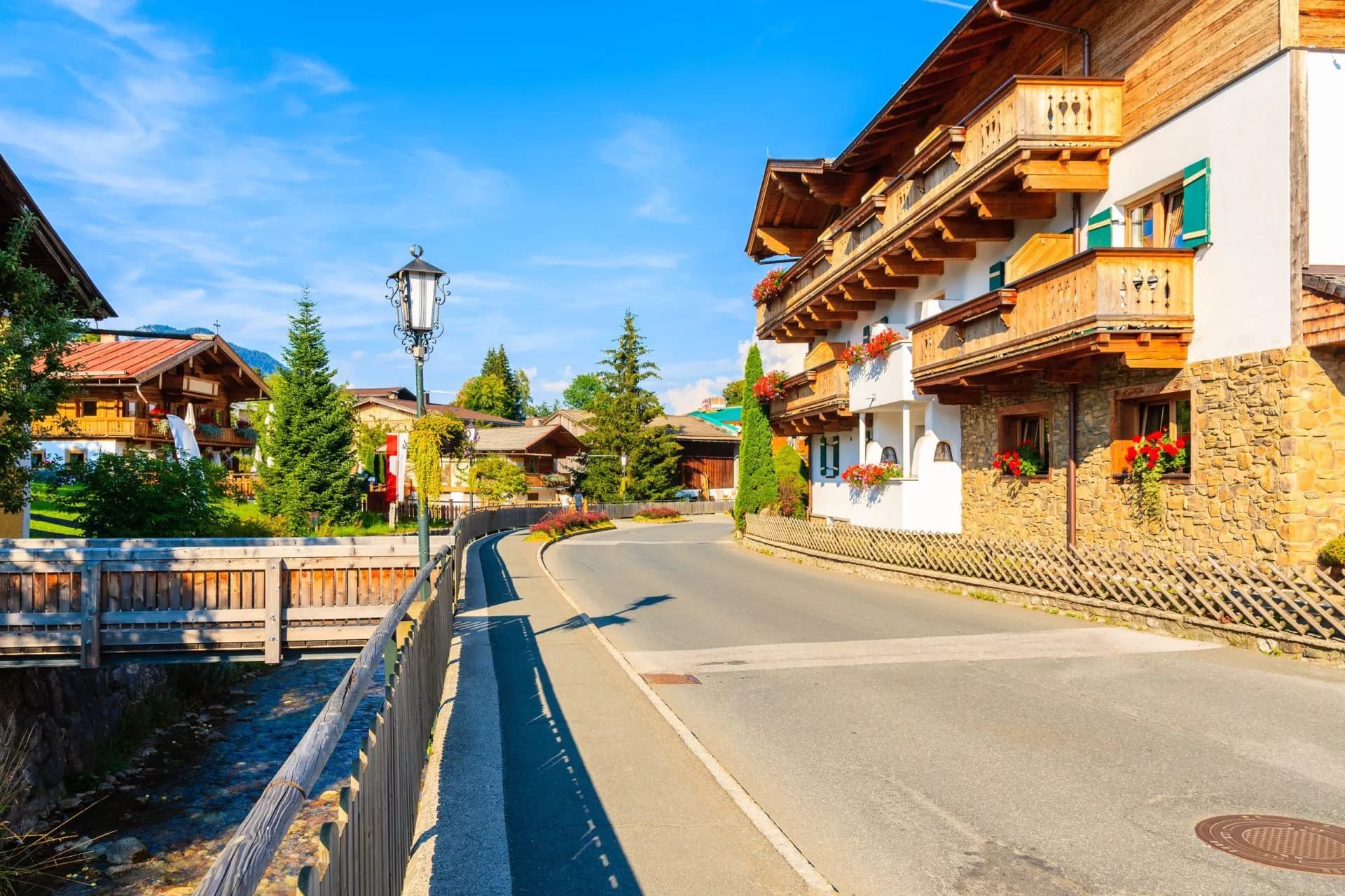 Traditional alpine houses on street in village of Going am Wilden Kaiser on beautiful sunny summer day, Tirol, Austria