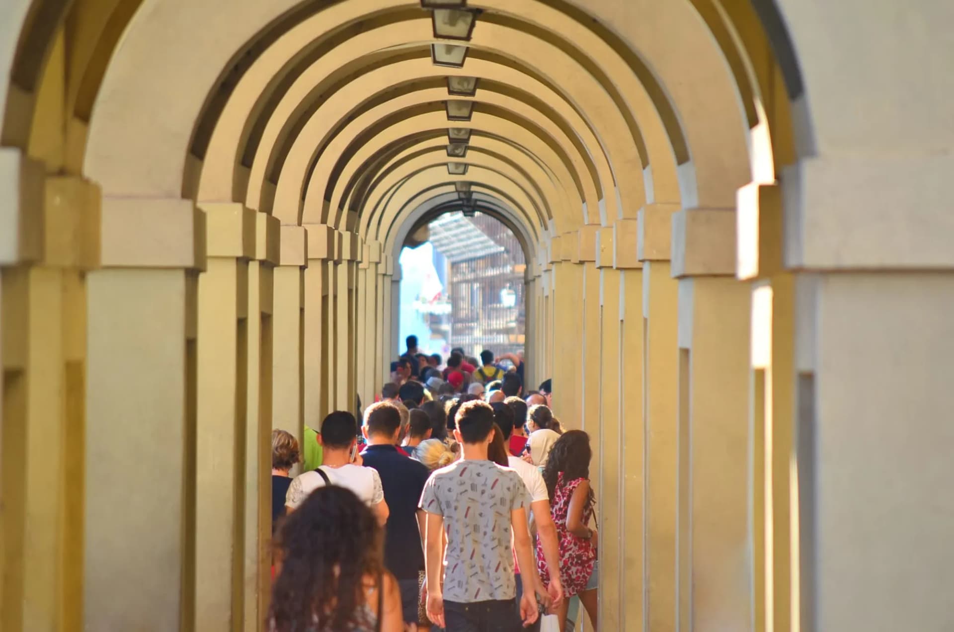 Passage with arch and people walking  in Florence, Italy