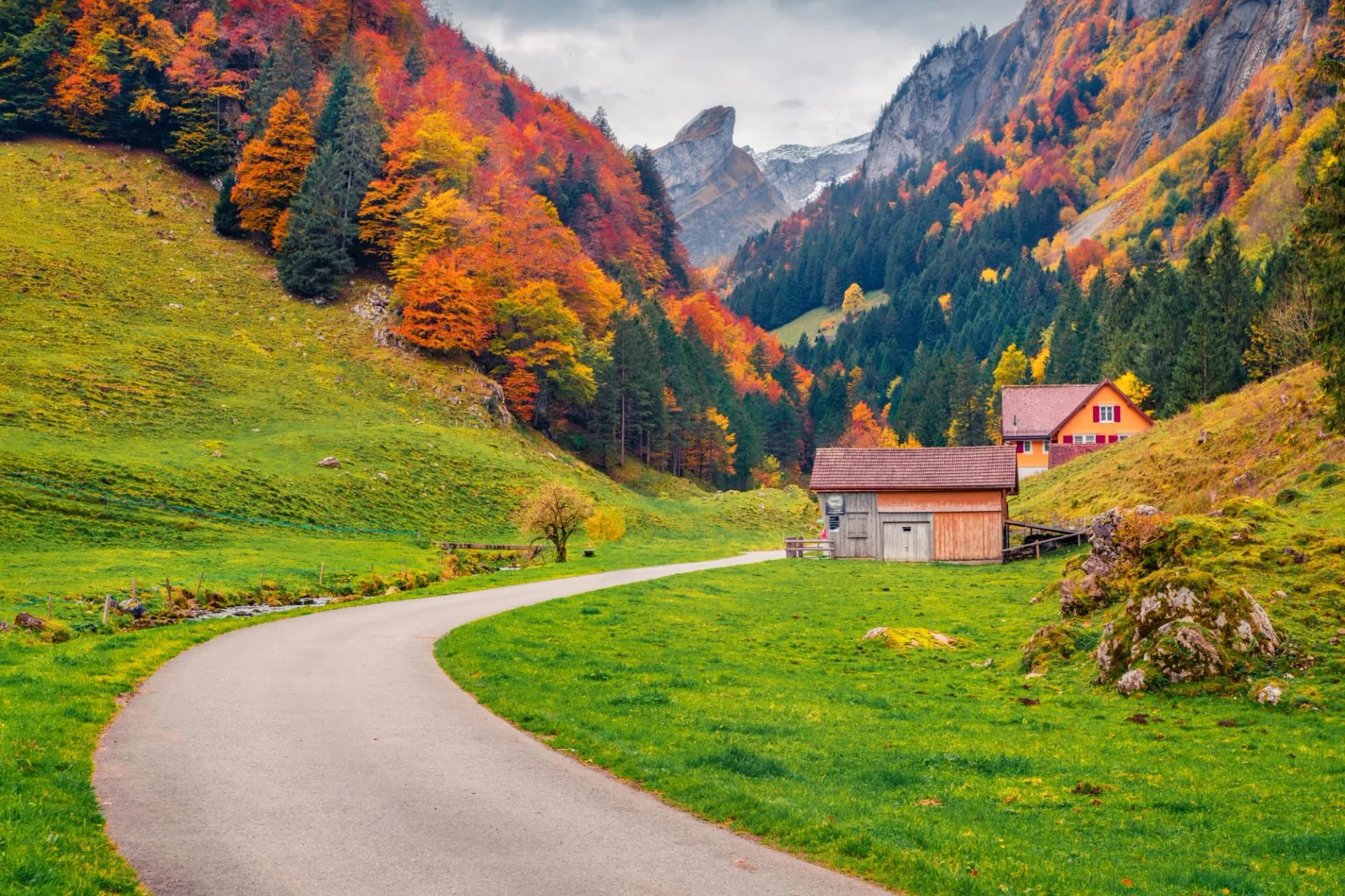 Captivating morning view of Swiss Alps with Santis peak on background. Spectacular autumn scene of Weissbad willage with country road, Switzerland, Europe. Traveling concept background..