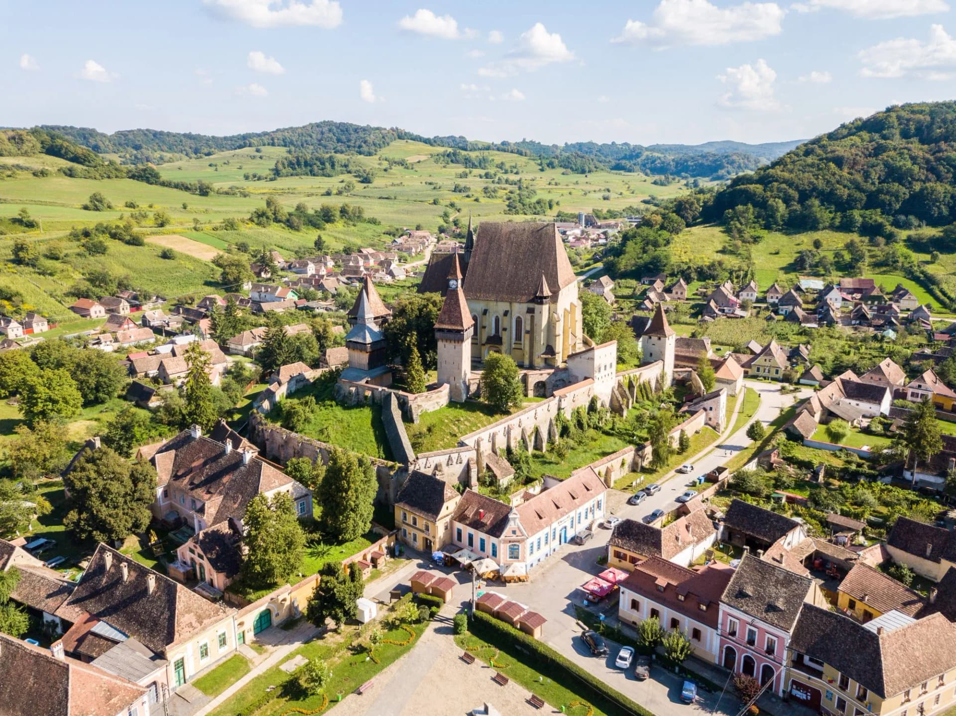 Biertan town and Biertan lutheran evangelical fortified church in Sibiu County, Transylvania, Romania. Aerial view. Biserica fortificata din Biertan, Sibiu, Transilvania, Romania
