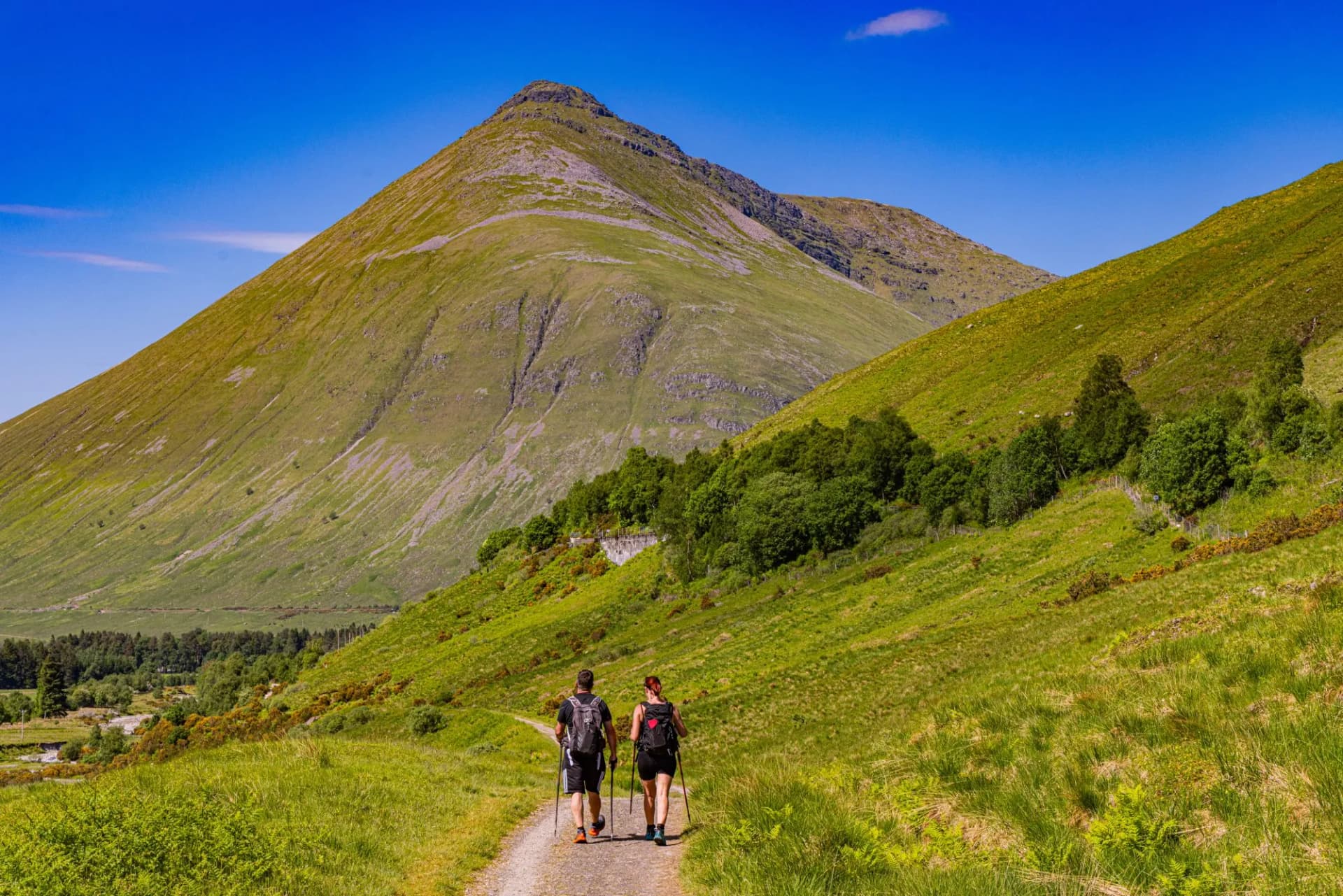 Exploring trails beneath the towering Highland mountains