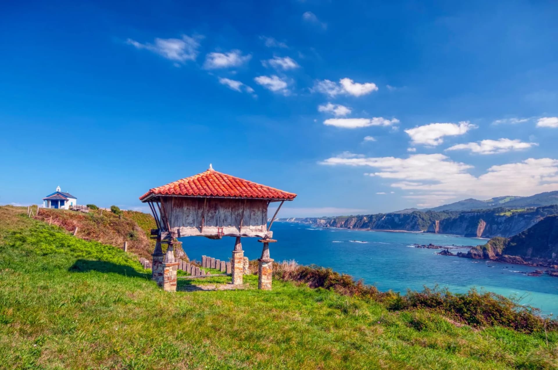 Typical granary and the chapel of La Regalina in Cadavedo, Asturias, Spain