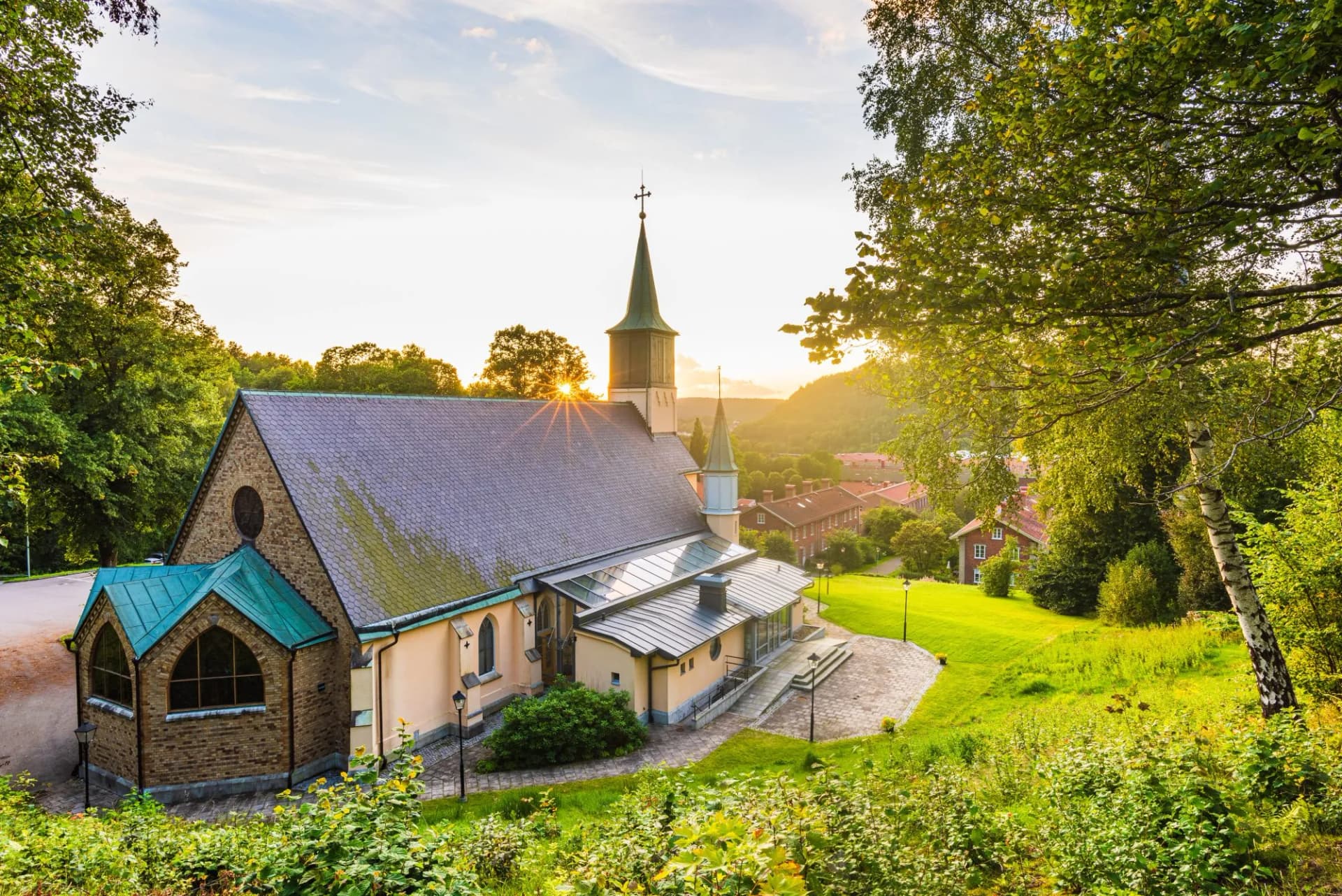 Church building against setting sun. Jonsered, Sweden.