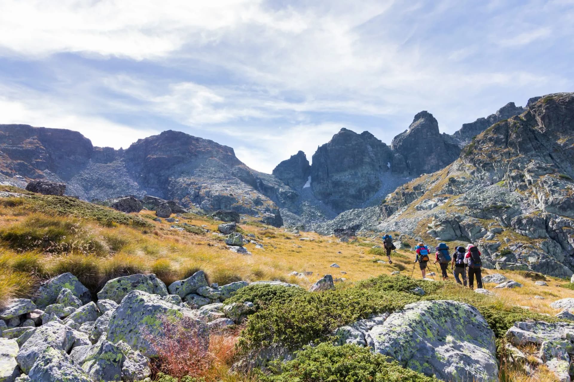 Group backpackers walking mountains. Rila range, Bulgaria.