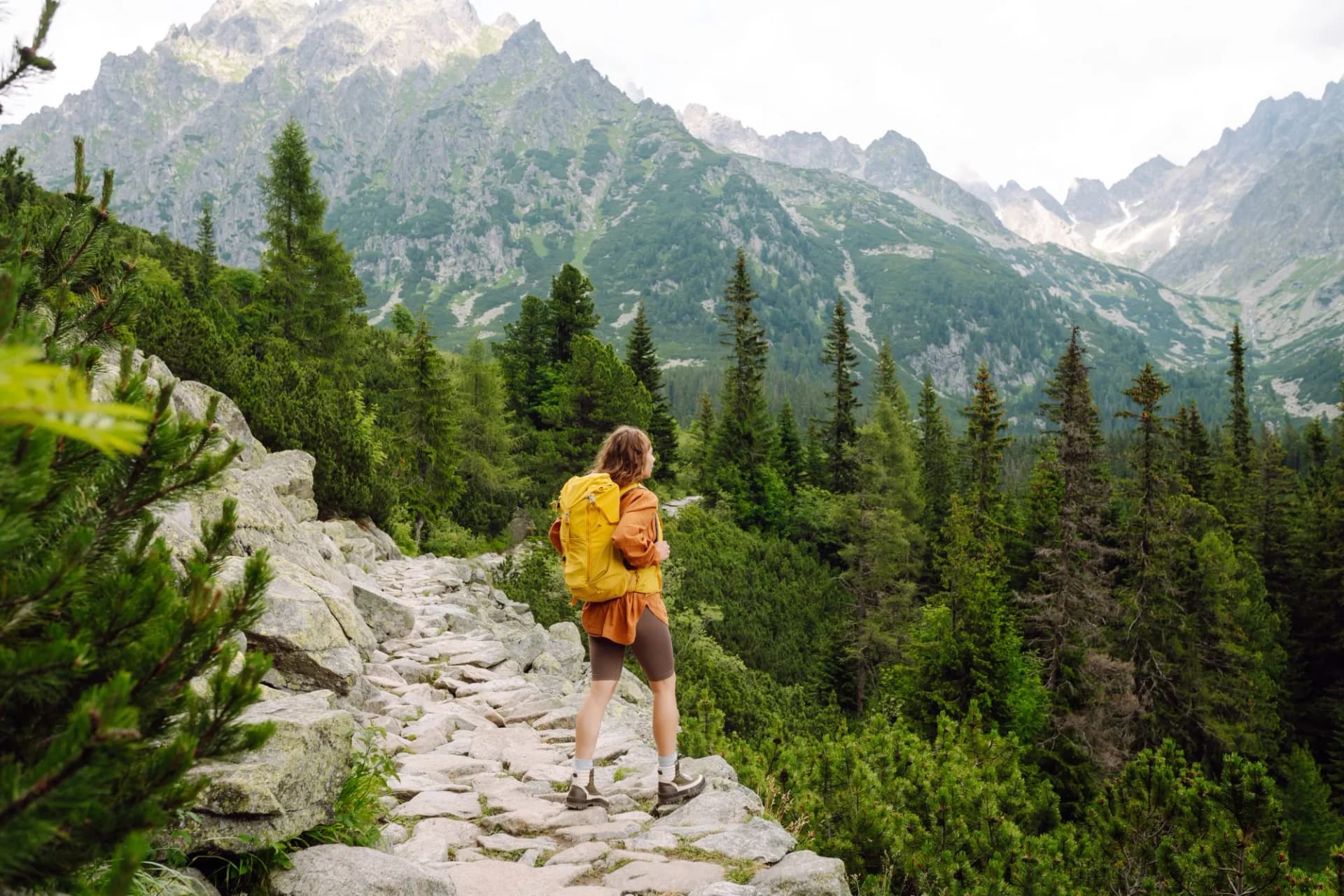 Portrait of a successful tourist on the mountain and enjoying freedom. Concept of trekking, active lifestyle. Adventures
