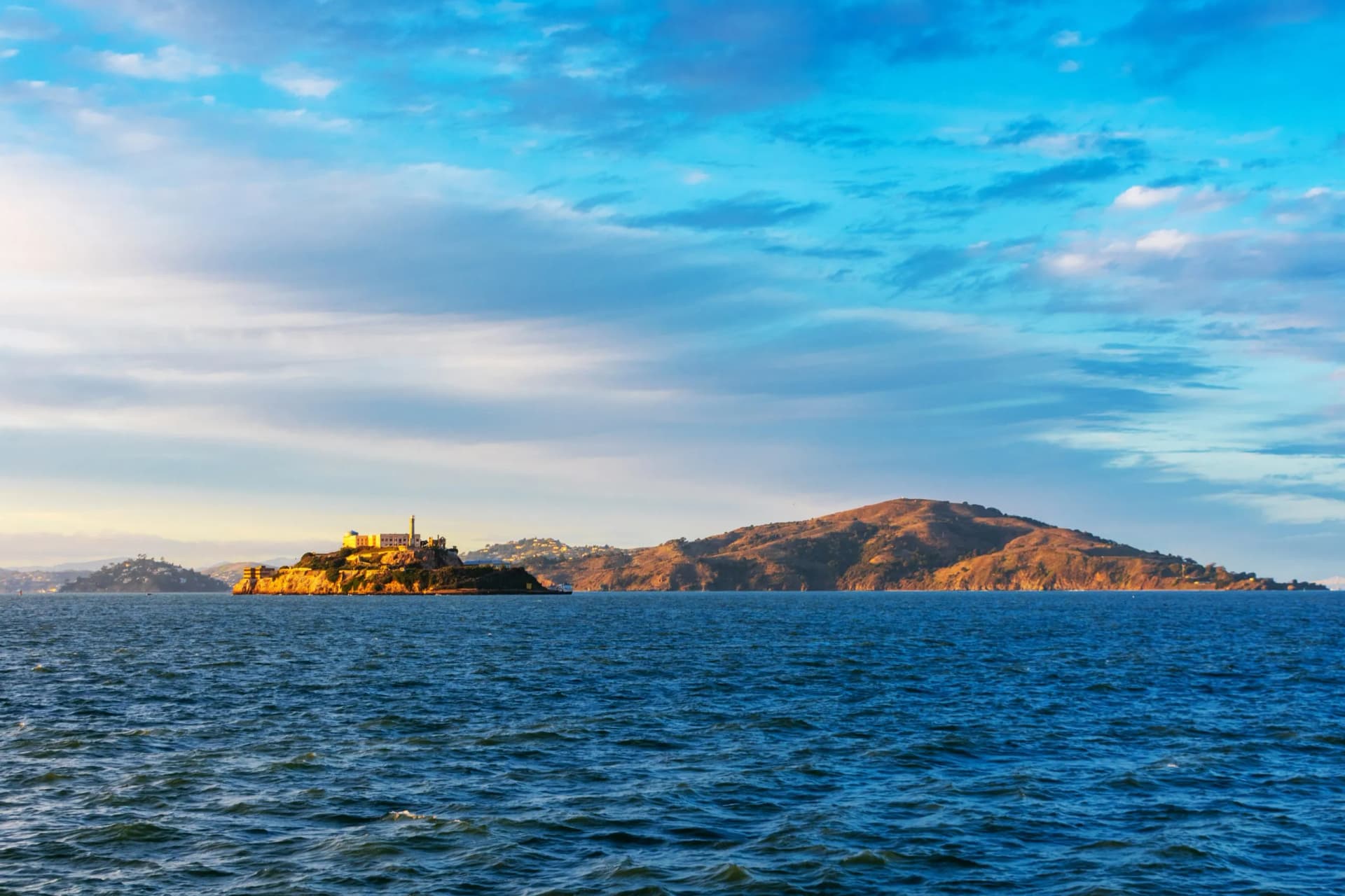 Sunset view of scenic San Francisco Bay coastline from the pier in San Francisco in the direction of Tiburon, Alcatraz and Angel islands